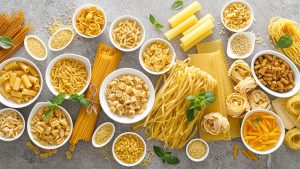 Pasta.,Various,Kinds,Of,Uncooked,Pasta,And,Noodles,Over,Stone